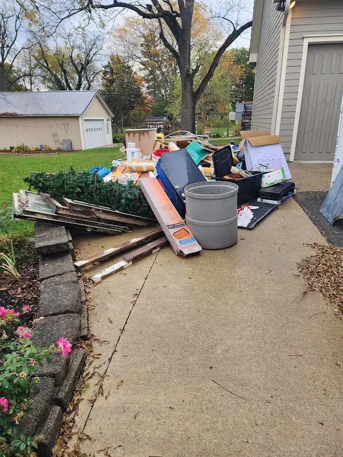Dumpster being loaded with debris for 12 Yard Dumpster Rental in Wesley Chapel